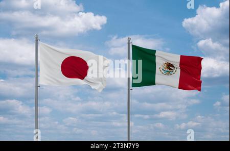 Mexico and Japan flags waving together on blue cloudy sky, two country relationship concept Stock Photo