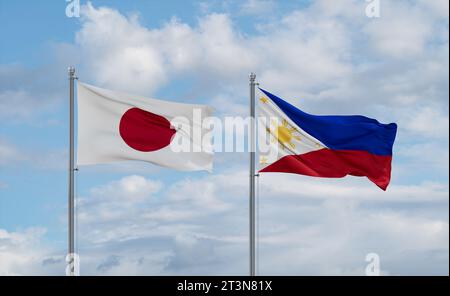 Philippines and Japan flags waving together in the wind on blue cloudy sky, two country relationship concept Stock Photo