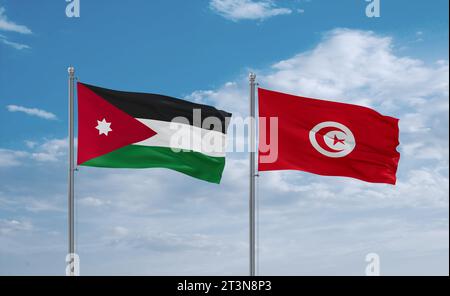 Tunisia and Jordan flags waving together in the wind on blue cloudy sky, two country relationship concept Stock Photo