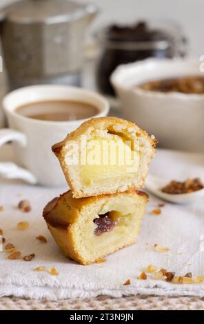 Pasticciotto leccese pastry filled with egg custard cream, typical sweet from Lecce, Italy. Pieces of pasticiotto on a beige napkin, apulian breakfast Stock Photo