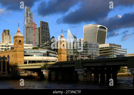 The river side view of Cannon Street railway bridge and station with the skyscrapers of the City of London financial district in the background.  Cann Stock Photo