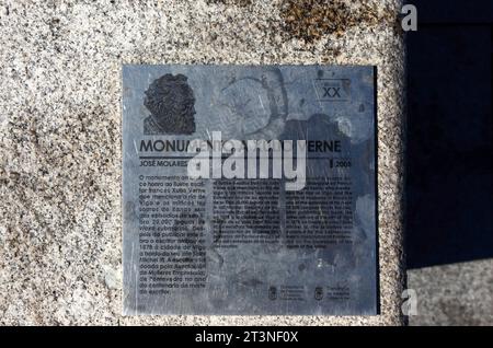 Sign in Galician and English languages on granite stone base of moument to the famous writer Jules Verne on the waterfront, Vigo, Galicia, northwest S Stock Photo