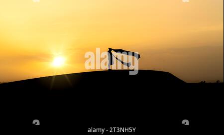 Silhouette of unidentified muslim Berber man praying on sand dunes at ...