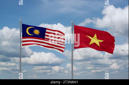 Vietnam and Malaysia flags waving together in the wind on blue cloudy sky Stock Photo