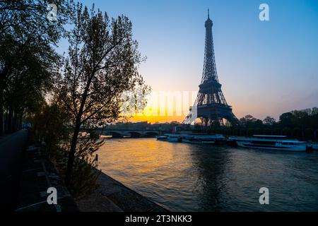 Eiffel Tower, French: Tour Eiffel, silhouette at sunrise time on sunny day. View from Seine River. Paris, France Stock Photo