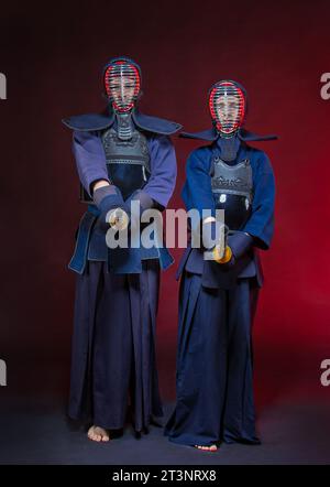 Two kendo fighters with Sinai isolated over dark space. The Japanese martial art of sword fighting. kendo concept. teacher or coach and student Stock Photo