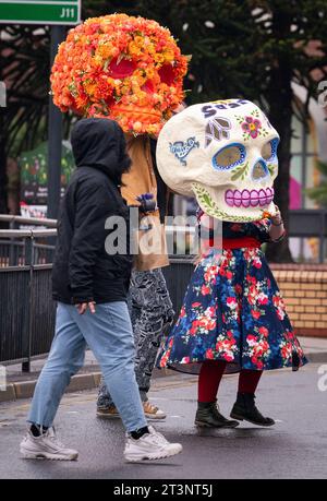 Skeleton heads are carried through Leeds city centre during a photocall for the All That Lives festival that sees artist Ellie Harrison and Zion Art Studio artists from Mexico reimagine the Day of the Dead in Yorkshire as part of LEEDS 2023 year of culture. Picture date: Thursday October 26, 2023. Stock Photo