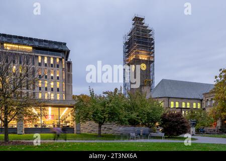 Ithaca, New York, US - October 25, 2023: Night photo of McGraw clock tower with construction scaffolding, landmark at Cornell University, and iconic p Stock Photo