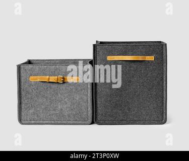 Two gray felt storage boxes with leather handles and buckles Stock Photo