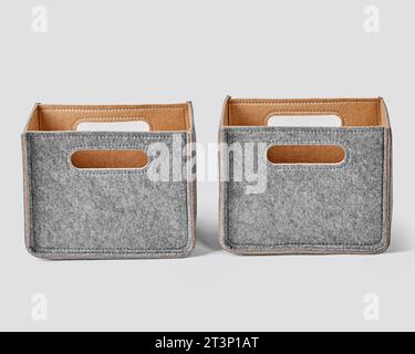 Two handcrafted boxes in gray felt with slotted handles for storage of things Stock Photo
