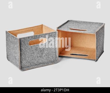 Two handcrafted felt boxes with slotted handles for storing things Stock Photo