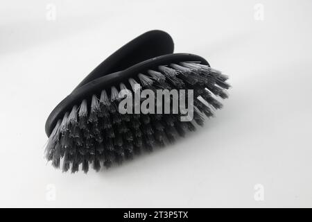 Plastic spike brush used by hand to clean dust from clothes or corners of the house that are dirty isolated on white background Stock Photo