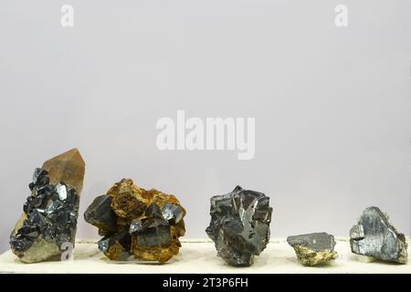 collection of various minerals on gray background : cassiterite stones Stock Photo