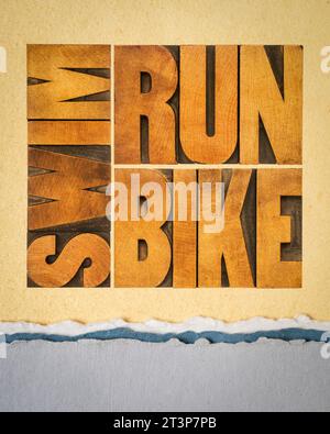 run, bike, swim - triathlon concept,  word abstract in vintage letterpress wood type on art paper, sport and recreation concept Stock Photo