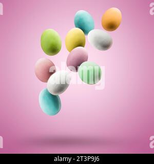 Colorful easter eggs floating on pink background. Stock Photo