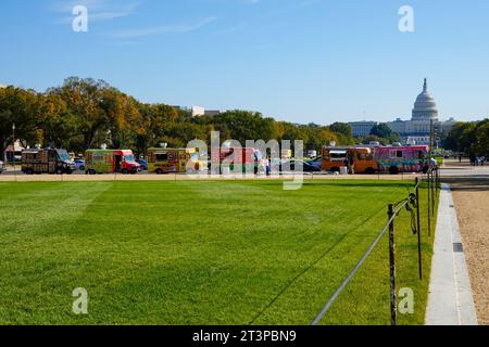 Food trucks line a street crossing the National Mall on a cloudless day in October, Washington, DC, USA. Stock Photo