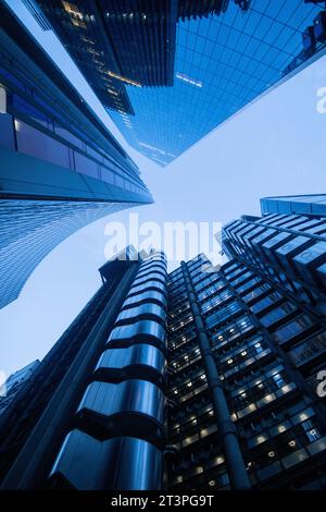 Looking up at Willis Building and Lloyds at Dusk in the Financial District, London England UK Stock Photo