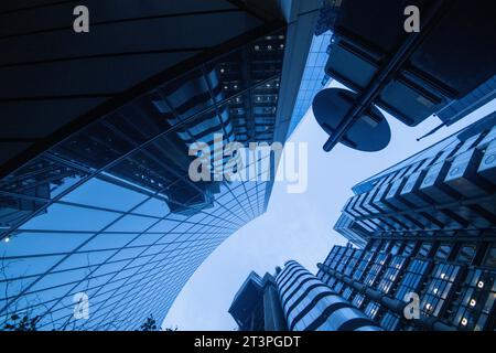 Looking up at Willis Building and Lloyds at Dusk in the Financial District, London England UK Stock Photo