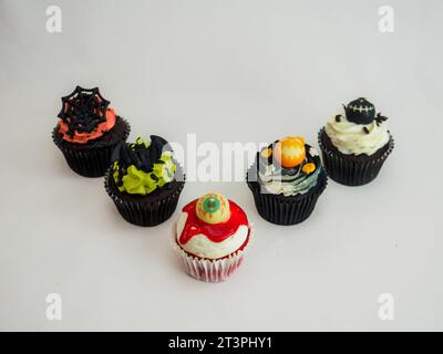 a set of horror halloween themed artsy cupcakes muffin isolated on white Stock Photo