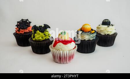 a set of horror halloween themed artsy cupcakes muffin isolated on white Stock Photo
