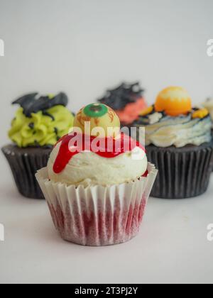 a set of horror halloween themed artsy cupcakes muffin isolated on white Stock Photo