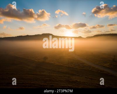 Dry fields at sunrise. Dramatic sunrise in foggy fields Stock Photo