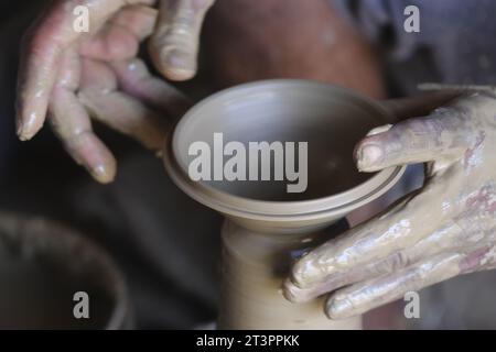 26 October 2023, Pune, India, Indian potter making Diya (oil lamps) or earthen lamps for Diwali Festival with clay, Handwork craft. Stock Photo