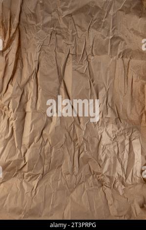 Crumpled brown recycled paper page with many fold lines Stock Photo