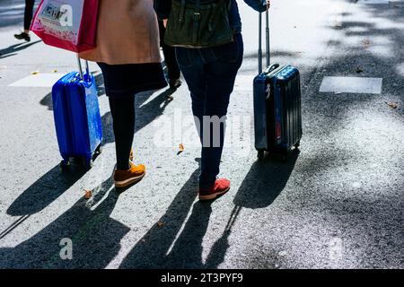 Women pulling a suitcase in the city. Madrid, Community of Madrid, Spain, Europe. Stock Photo