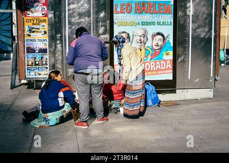 Group of Romanian immigrants sitting on the ground. Puerta del Sol, Madrid, Comunidad de madrid, Spain, Europe Stock Photo