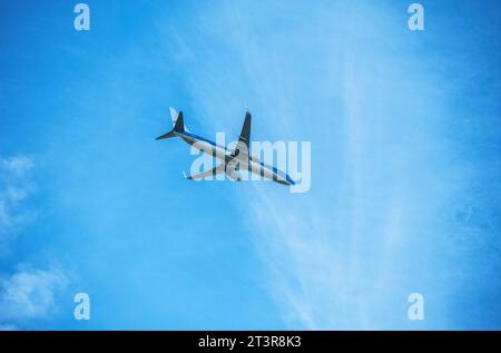 KLM passenger airplane flying across a blue sky Stock Photo