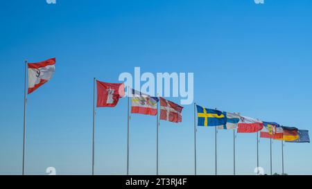 National and international flags waving in the wind Stock Photo