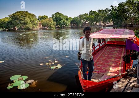 Boat man standing in Kolayat Lake, Kolayat, Rajasthan, India Stock Photo