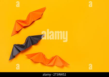 Different origami bats on orange background Stock Photo