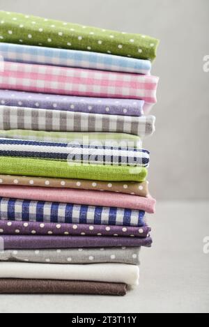 Clean kitchen textiles made of cotton and linen - napkins, towels folded on the light background Stock Photo