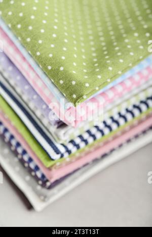 Clean kitchen textiles made of cotton and linen - napkins, towels folded on the light background Stock Photo