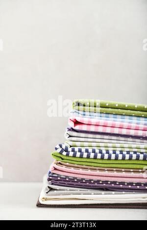 Clean kitchen textiles made of cotton and linen - napkins, towels folded on the light background Stock Photo