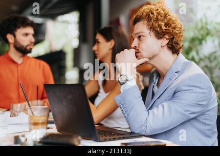 A collaborative team of architects, designers, and engineers strategize sustainable project planning, discussing costs, materials, and innovation. Stock Photo