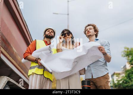 Collaborative Architectural Team Strategizing Sustainable Design for New Project Stock Photo