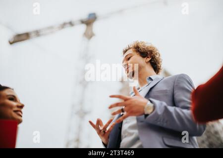 Architects and engineers discuss project details, walk through the construction site, and ensure successful design implementation. Stock Photo