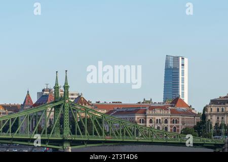 Liberty bridge (Freedom bridge) over the Danube river, with a new tower block is in the background. Budapest, Hungary Stock Photo