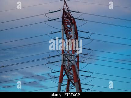 Hight voltage electric towers during sunset. Stock Photo