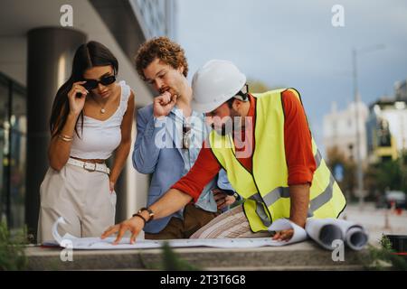 International Team of Architects Collaborating on a Creative Construction Project Stock Photo