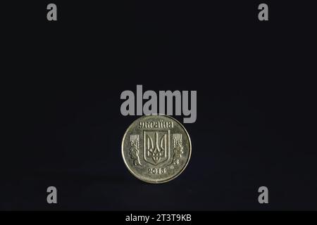 Picture of a ukrainian coin, hryvnia, isolated on a black background. The hryvnia or hryvnya has been the national currency of Ukraine since 2 Septemb Stock Photo