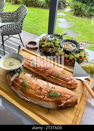 Smoked salmon with vegetables and dip on porch table Stock Photo