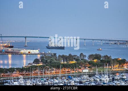 San Diego, California, USA. 20th Apr, 2005. Pleasure boats docked in San Diego Bay, and looking out over Embarcadero Marina Park to a U.S.Navy ship crossing under the Coronado Bridge. (Credit Image: © Ian L. Sitren/ZUMA Press Wire) EDITORIAL USAGE ONLY! Not for Commercial USAGE! Stock Photo