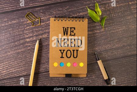 WE NEED YOU! message on the card shown by a businesswoman, vintage tone. Stock Photo