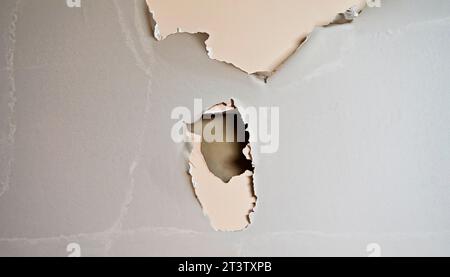 Busted drywall with torn hole. Stock Photo