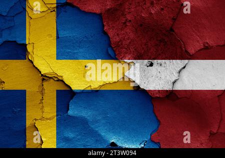 flags of Sweden and Latvia painted on cracked wall Stock Photo
