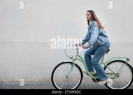 Side view woman riding her bike Stock Photo